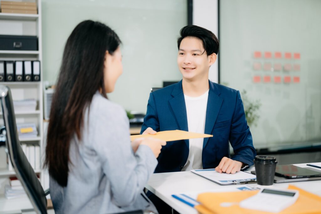 Asian business team and lawyers discussing contract papers sitting at the table. Concepts of law,