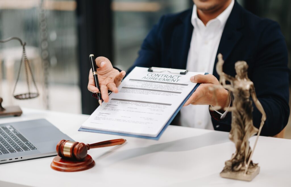 justice and law concept .Asian Male judge in a courtroom on table and Counselor working